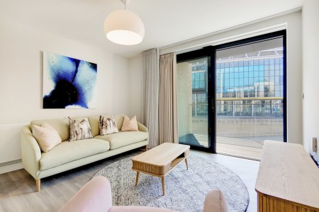living room with sofa, small table and large door to balcony, Wembley Apartments, Wembley, London HA9