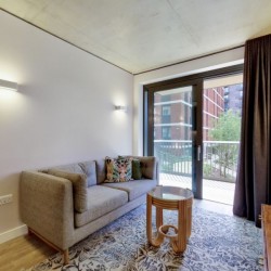 living room with sofa, small table, side table and open door to balcony, Wembley Apartments, Wembley, London HA9
