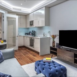 living room with sofa, foot stool, tv, dining table and kitchen, Chancery Lane Apartments, Holborn, London W1C