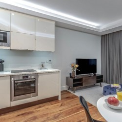 living room with dining area, kitchen, TV and view to balcony, Chancery Lane Apartments, Holborn, London W1C