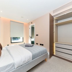 bedroom with double bed, cushions and wardrobe, Southern Apartments, North Kensington, London W10