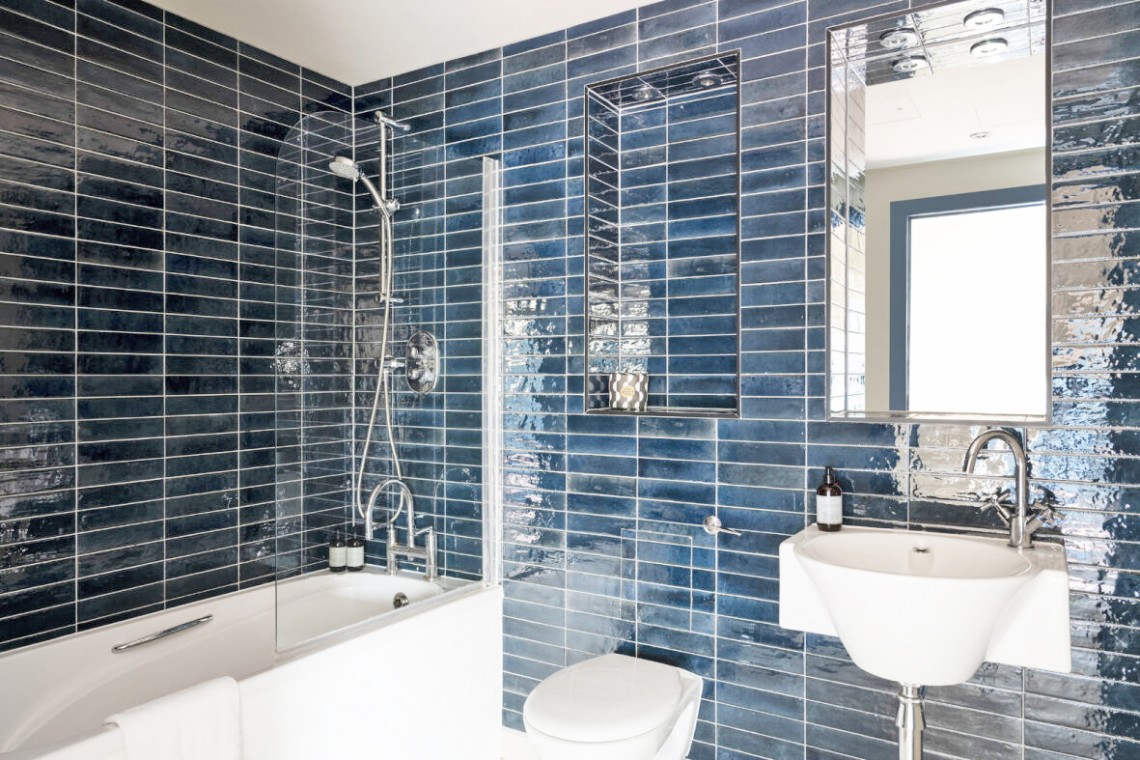 bathroom with blue tiles, bathtub, toilet, sink and mirror, Cromwell Road Executive, Kensington, London SW5