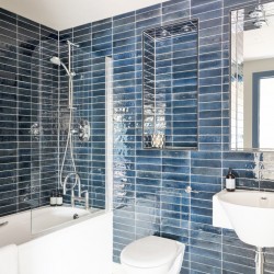 bathroom with blue tiles, bathtub, toilet, sink and mirror, Cromwell Road Executive, Kensington, London SW5