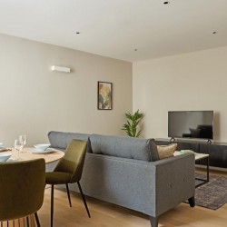 living room with dining table, chairs, back of sofa, side console with TV, Holborn Apartments, Holborn, London WC2