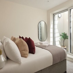 double bed with large cushions, mirror and patio, Munster Apartments, Fulham, London SW6