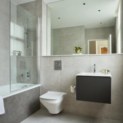 bathroom with bathtub and shower, toilet, sink and large mirror, Holborn Apartments, Holborn, London WC2