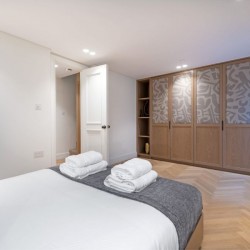 bedroom with double bed, towels and large wardrobe, Covent Garden Deluxe, Covent Garden, London WC2