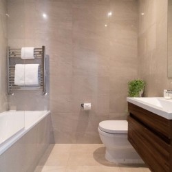bathroom with bathtub, toilet, sink and mirror, Barons Court Apartments, Hammersmith, London W6