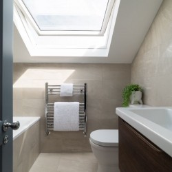 bathroom with tub, towel rail, toilet and sink, Barons Court Apartments, Hammersmith, London W6