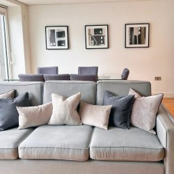 large grey sofa with cushions, dining table and prints on the wall, Marylebone Apartments, Marylebone, London W1U