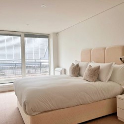 bedroom with double bed with cushions, set of drawers, side table with lamp,Marylebone Apartments, Marylebone, London W1U