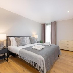 bedroom with double bed and side table with lamp, Southbank Apartments, Southwark, London SE1
