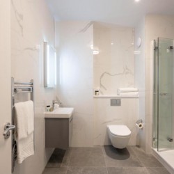 bathroom with sink, toilet, towel rail and shower, The Executive Residences, Tower Hill, London EC3