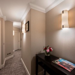 hallway with several doors, side console and wall lamp, The Executive Residences, Tower Hill, London EC3