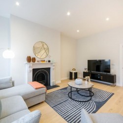 living area with sofa, fireplace, round table and TV, Covent Garden 1, Covent Garden, London WC2