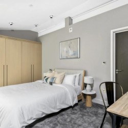 double bedroom with wardrobe and work desk, West End Apartments, Holborn, London W1C