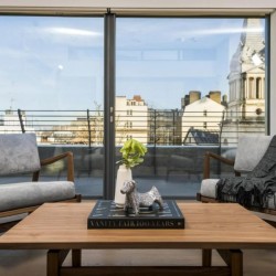 living room with table, two chairs and view to church, West End Apartments, Holborn, London W1C